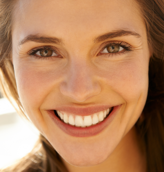Smiling woman outside with healthy teeth